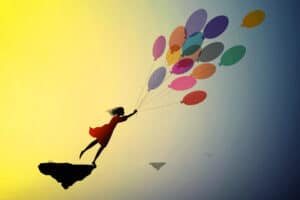 Possibilities - girl being lifted up into air by balloons